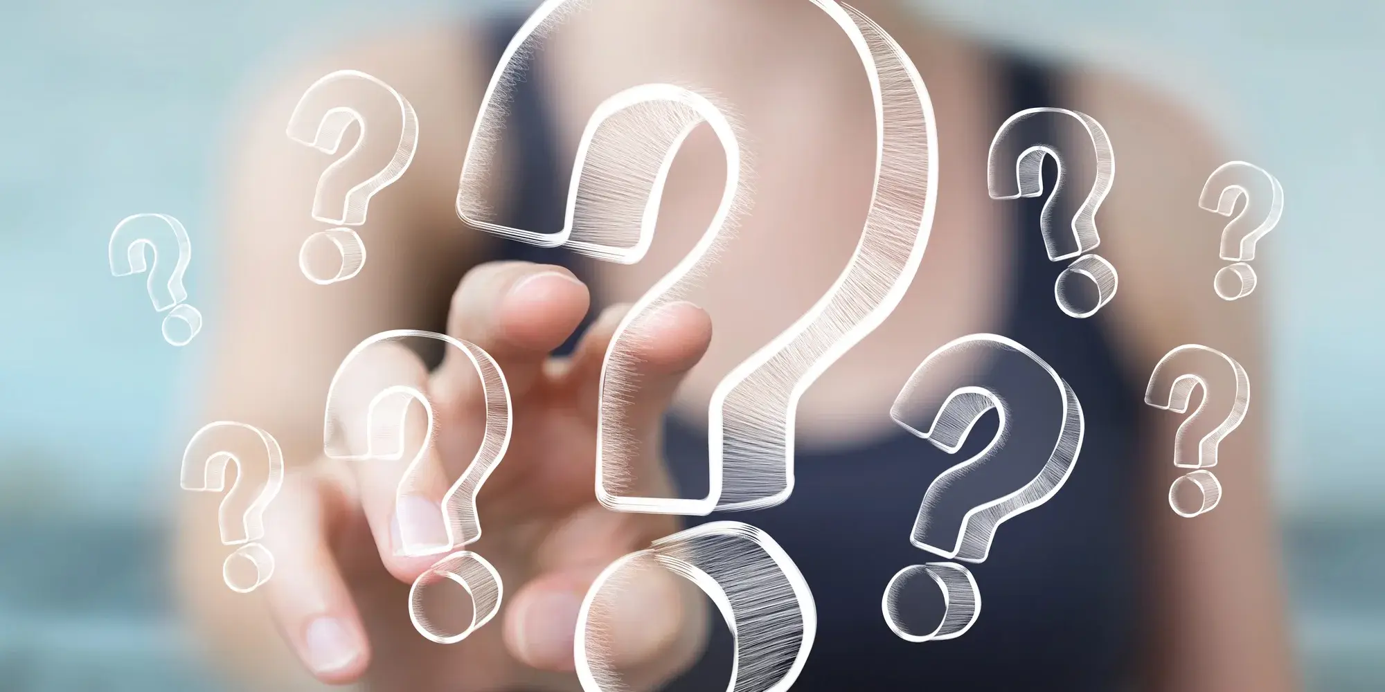 A hand reaching towards a cluster of illustrated question marks