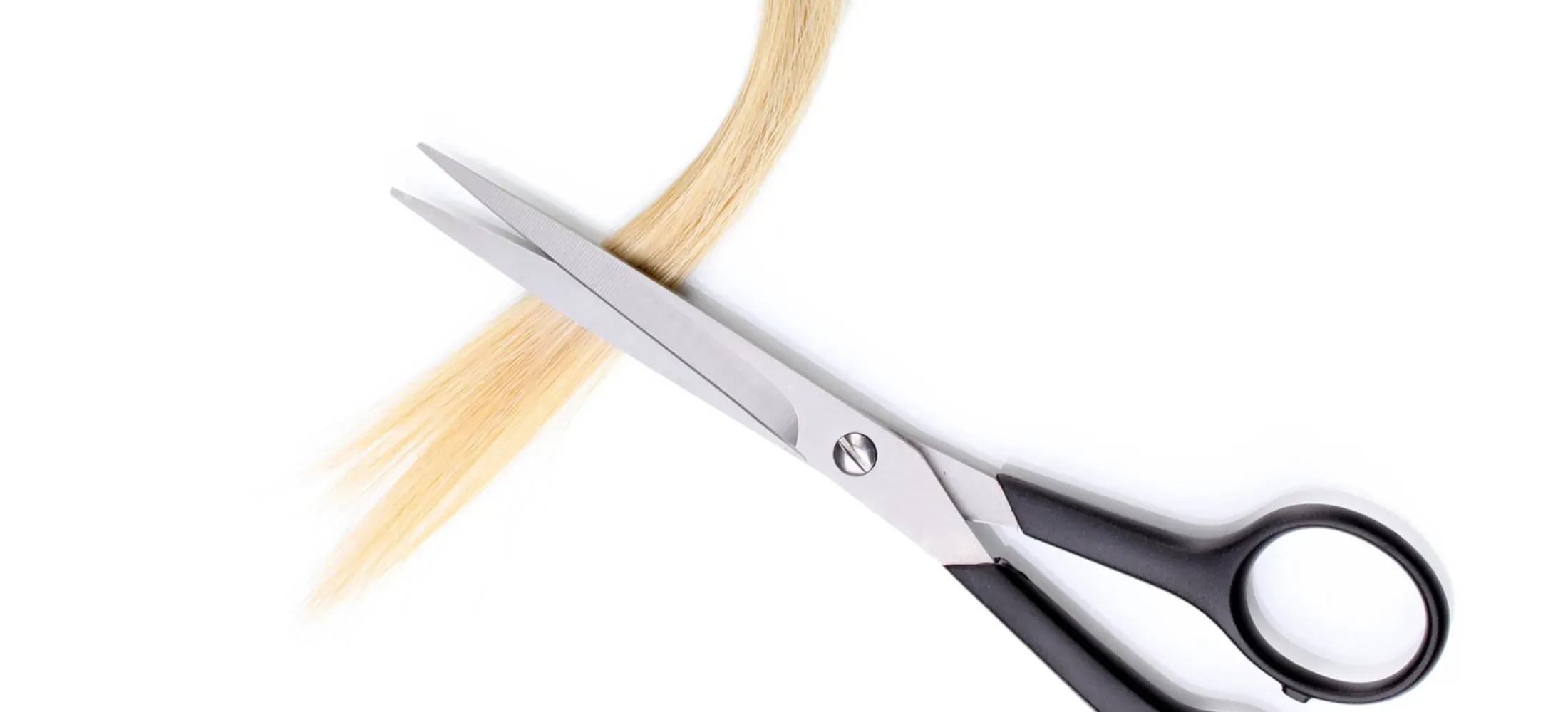 Scissors cutting a lock of blonde hair against a white background