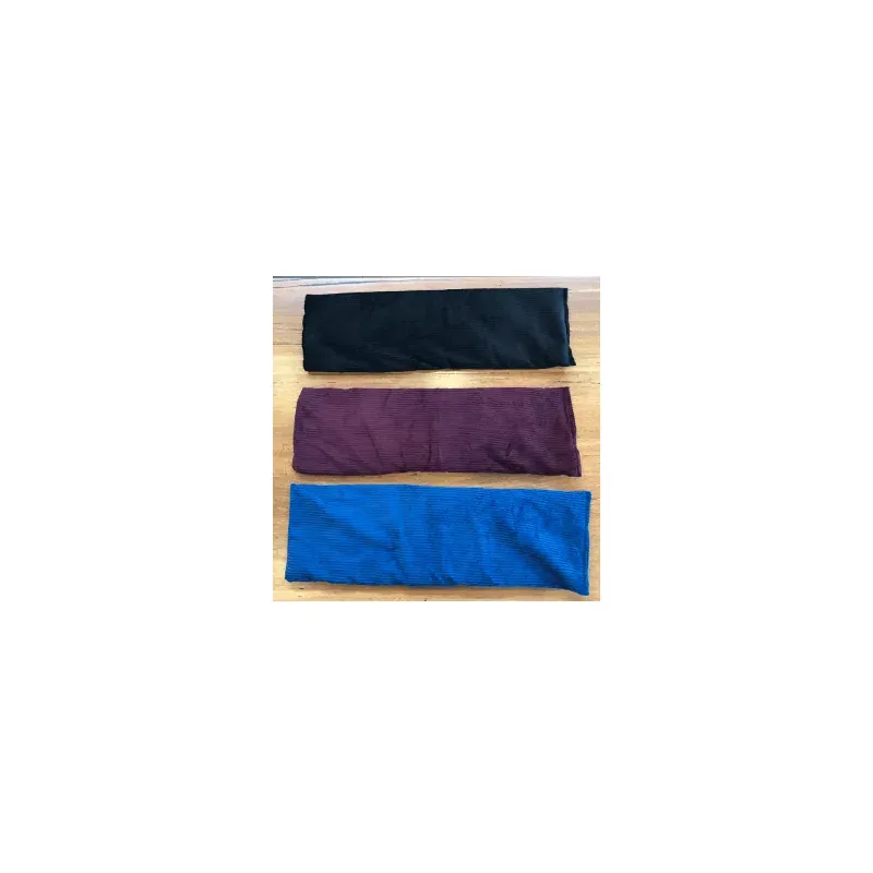The extra-long heat pack in its three colours — black, burgundy and blue — laid out side by side