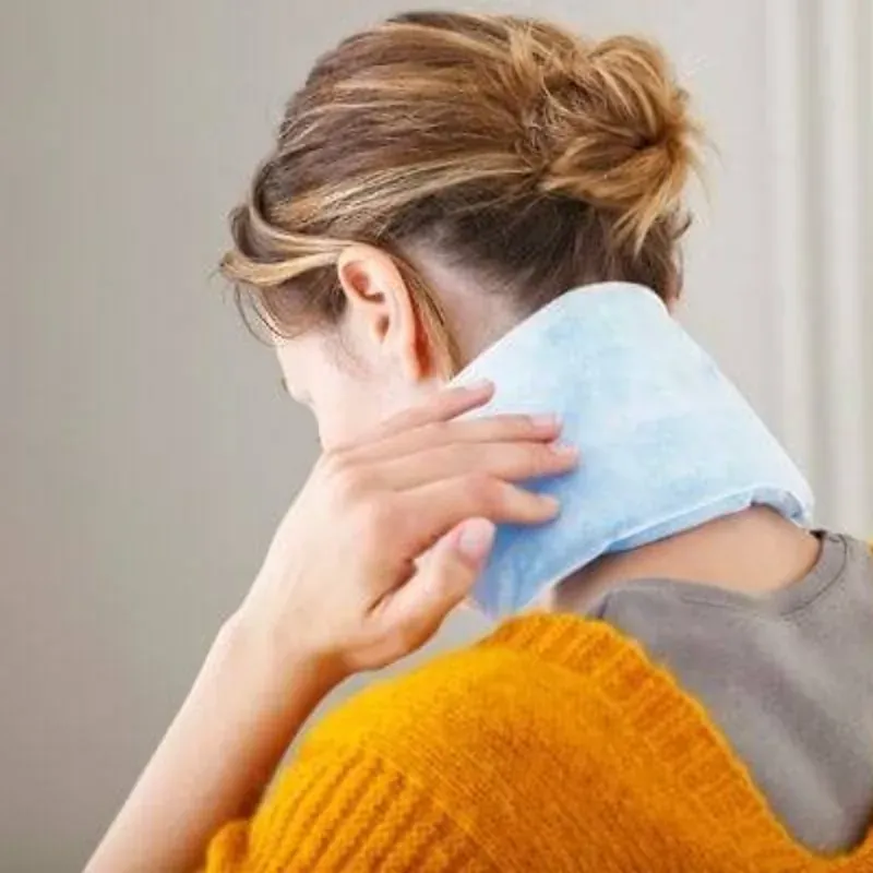 An extra-long heat pack draped across a person's neck and shoulders
