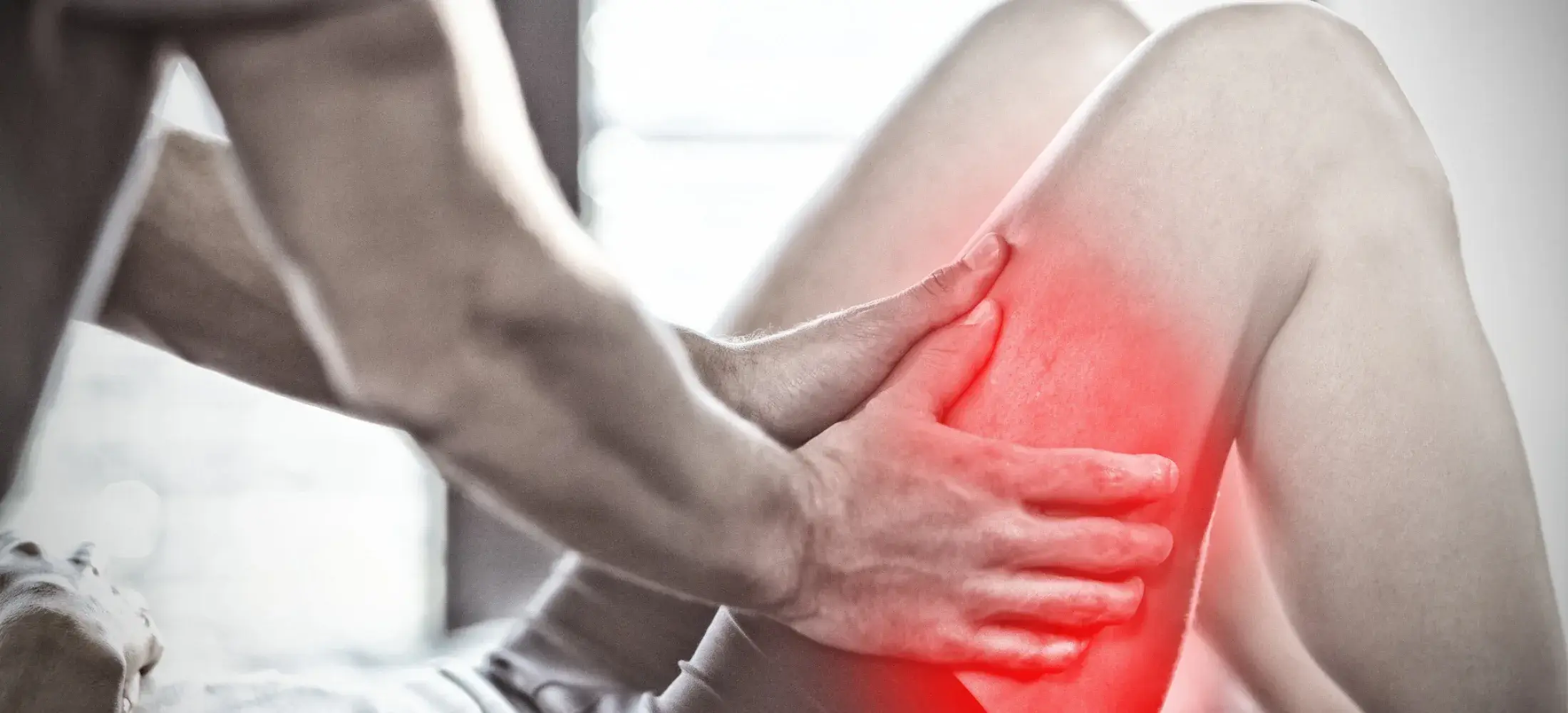 Hands gripping the outer side of a bent knee, the area highlighted
