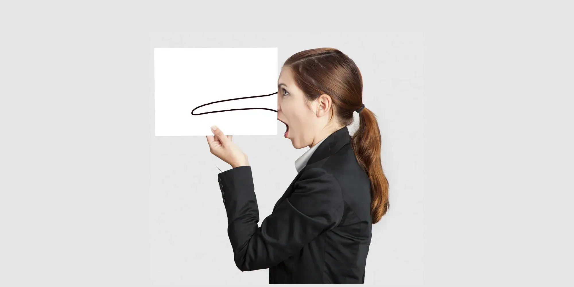 A woman in a suit holding a blank white sign, with a long Pinocchio-style nose drawn from her open mouth across the sign