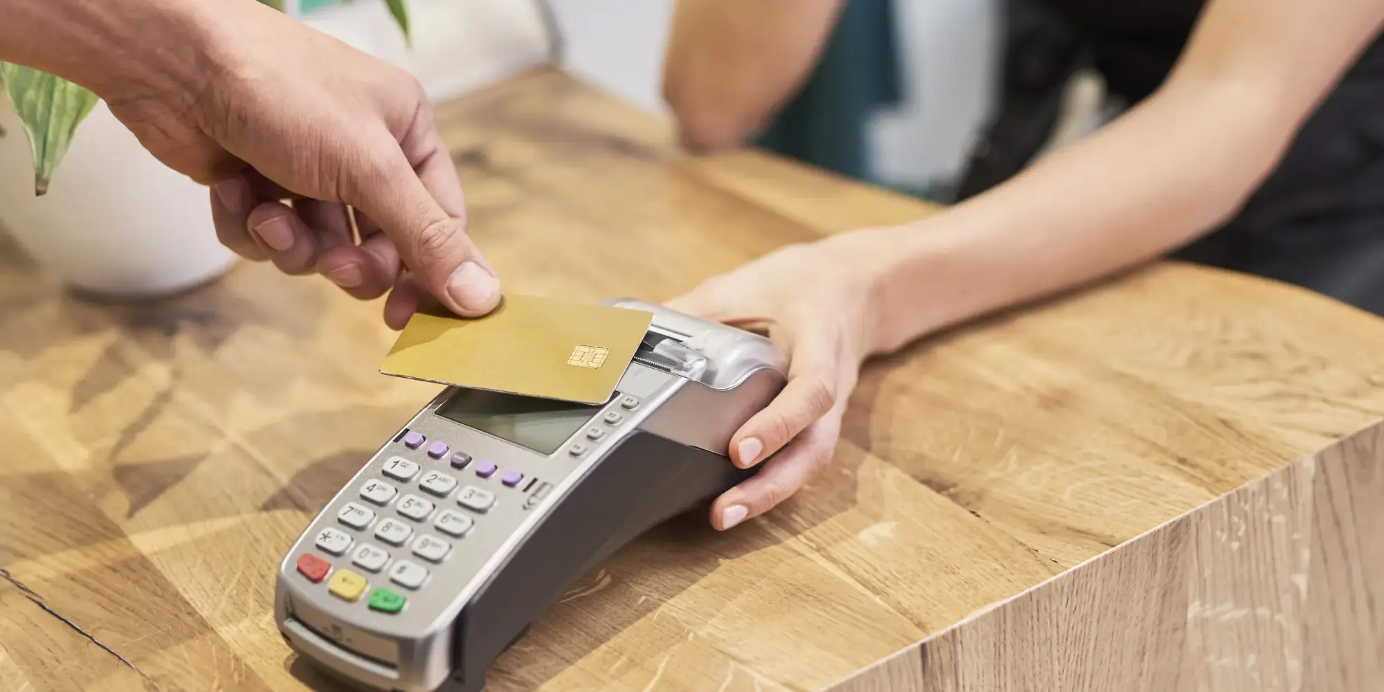 Paying for an appointment by card on the terminal at a reception counter