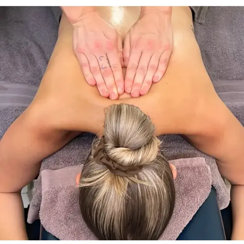 A back massage in progress on a treatment table