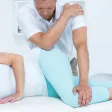 A practitioner using both hands on a side-lying patient's hip and lower leg on a treatment table