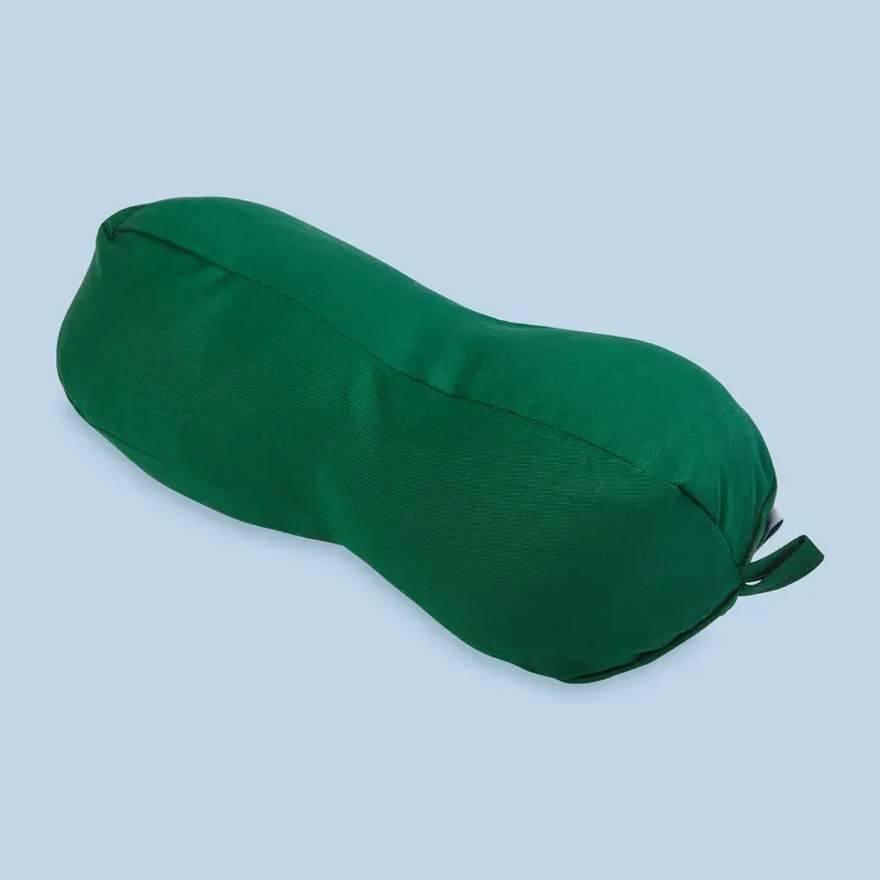 A peanut-shaped travel pillow in a green cotton cover, with a hanging loop at one end