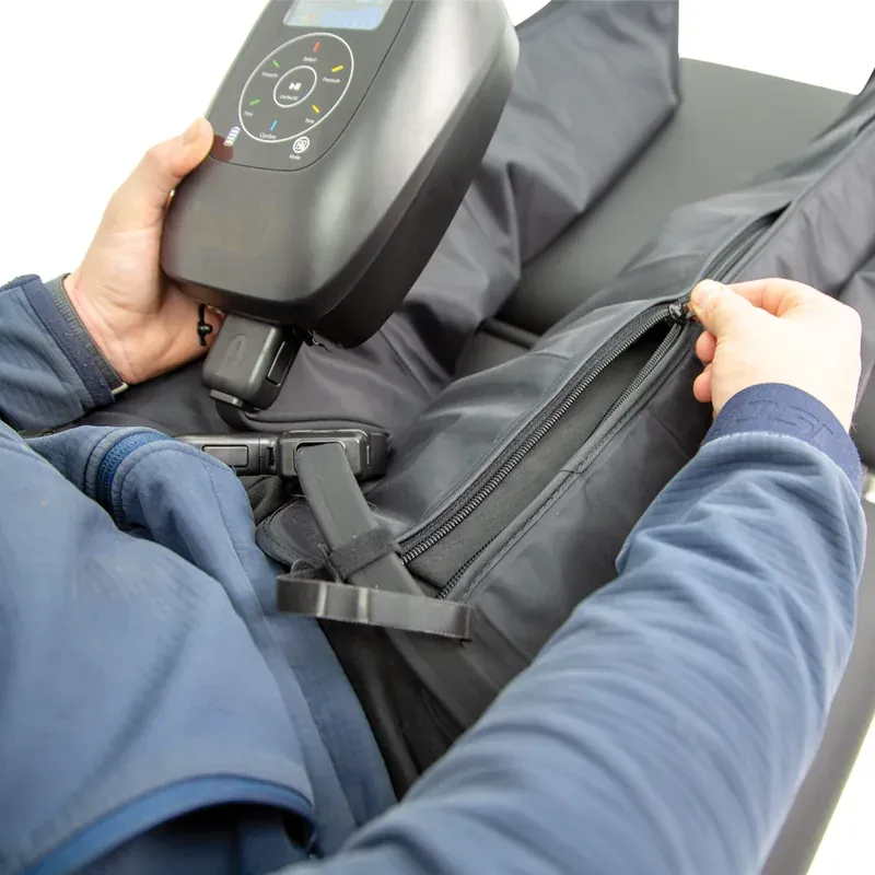 Close-up of the boot being zipped shut around the leg, showing the strap that sets the fit