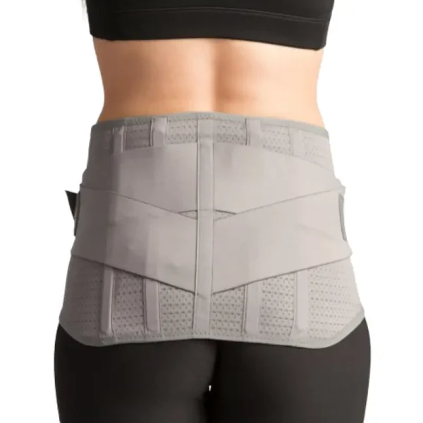 Close-up of a woman wearing a gray sacro-cinch low back support belt, designed for lumbar stabilization and pain relief