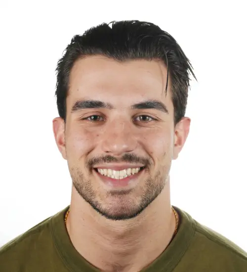 Portrait of Demetrius Mousaferiadis a smiling remedial massage therapist in Brunswick in a green shirt.