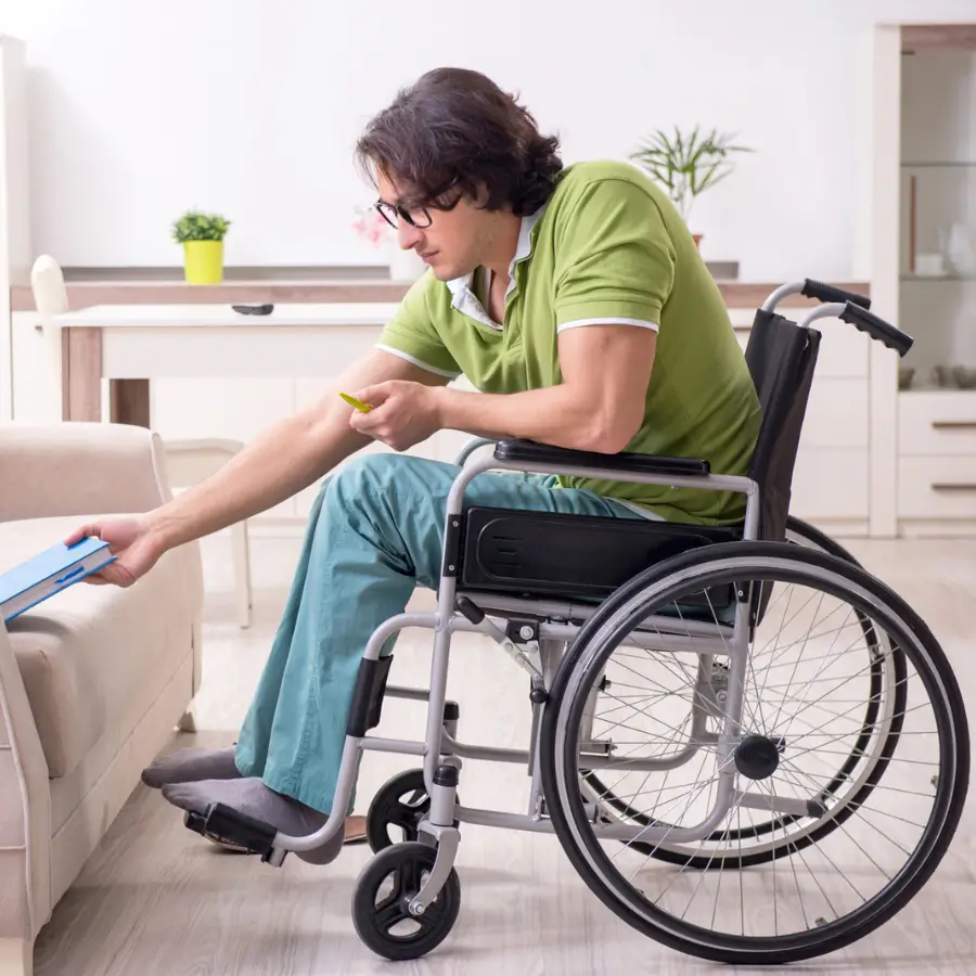 Paraplegic individual organizing files in wheelchair for NDIS support