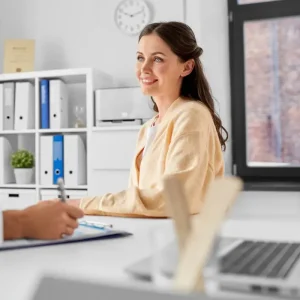 Smiling woman during a naturopathy consultation in a modern clinic setting