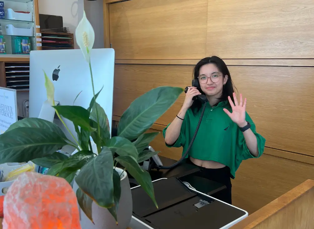Receptionist greeting clients at Brunswick Health Hub